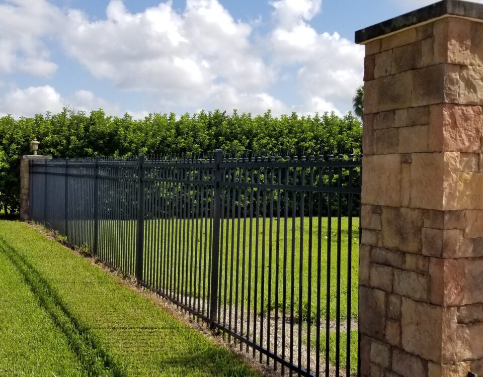 aluminum fence installation with brick pillars